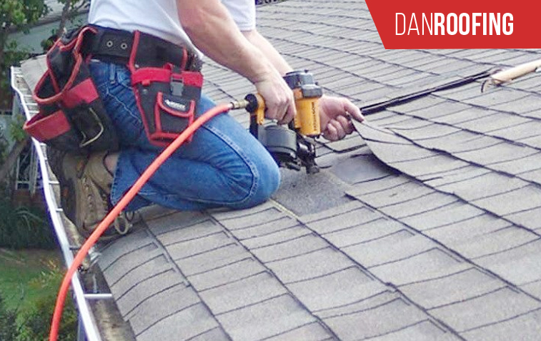 Worker repairing a roof with tools to fix damage